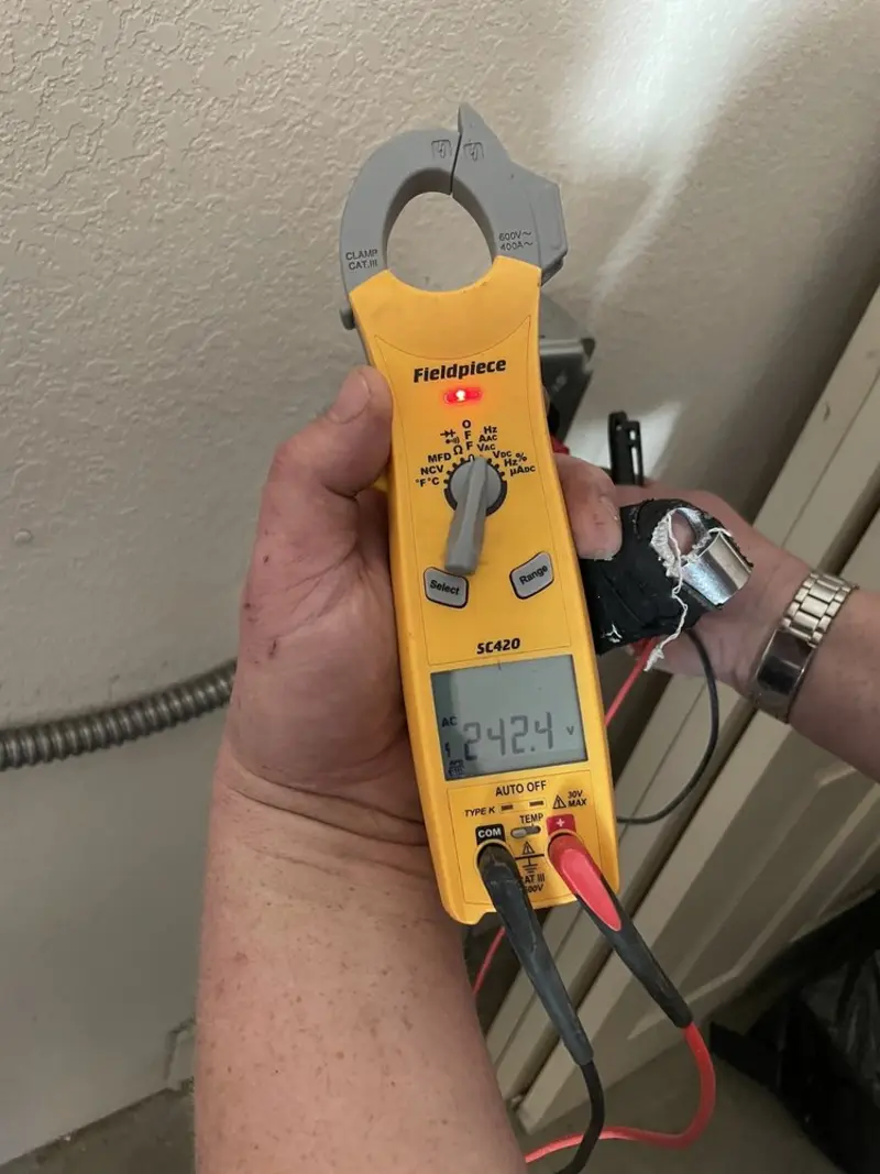 Voltage testing with clamp meter during Outlet Installation in Huntington